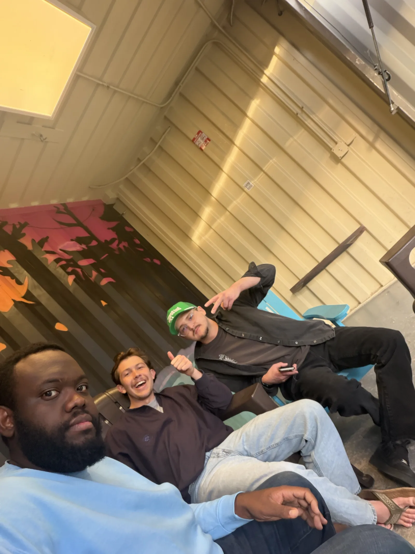 Anton with two friends spending time together indoors.